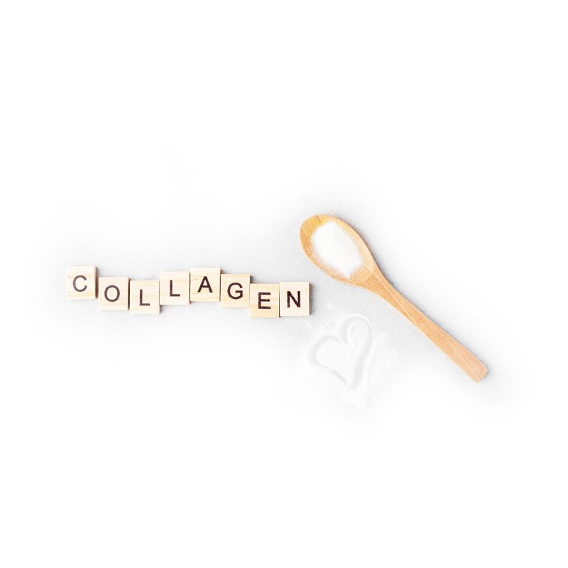 Life Extension, collagen powder on wooden spoon, pile of powder with heart drawn into it,  next to 'collagen' in wooden letter blocks with white background 